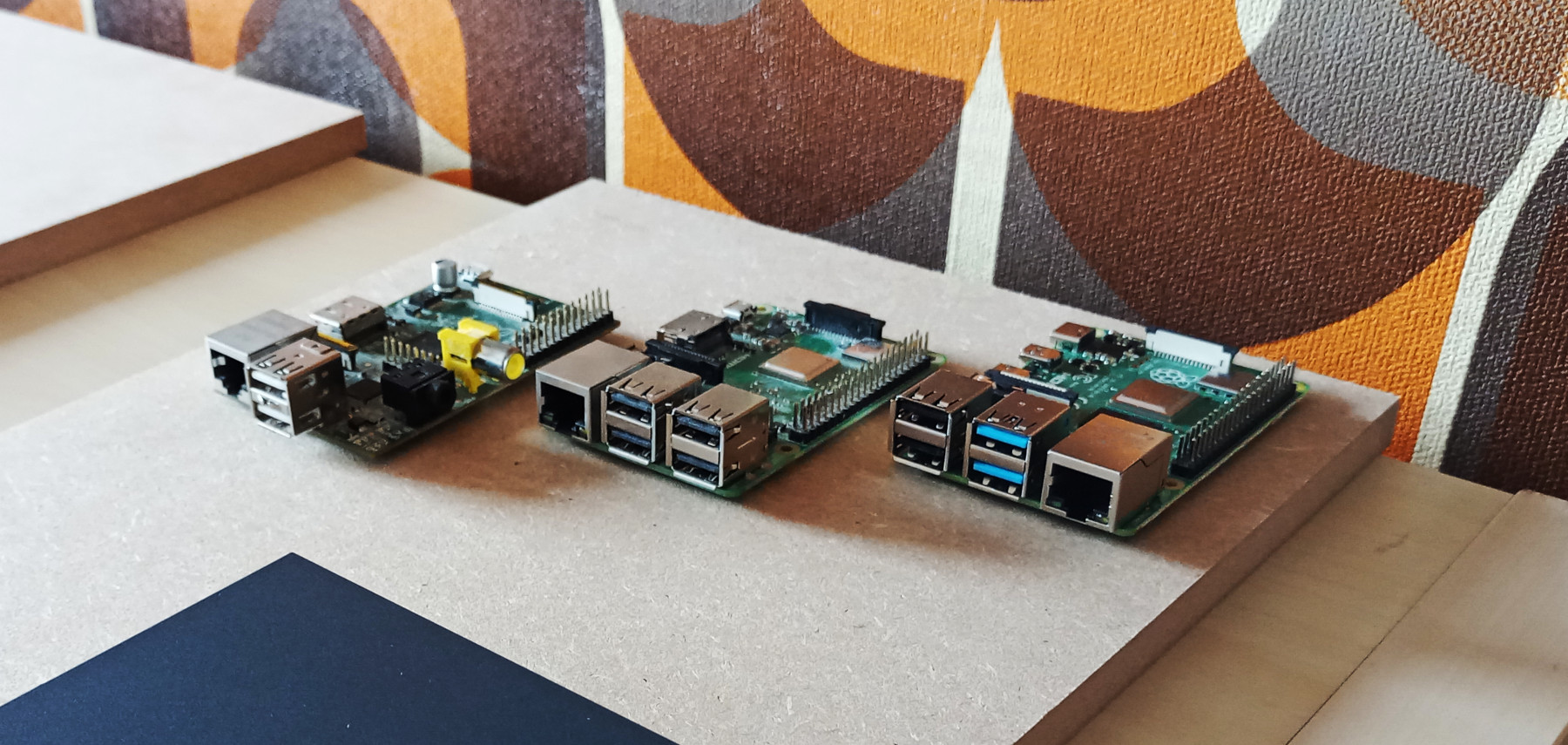 3 raspberry pis on a piece of wood