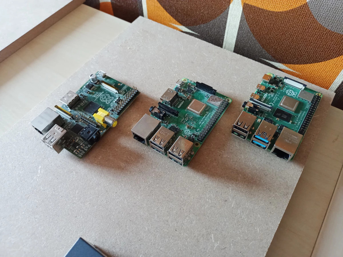 3 raspberry pis on a piece of wood