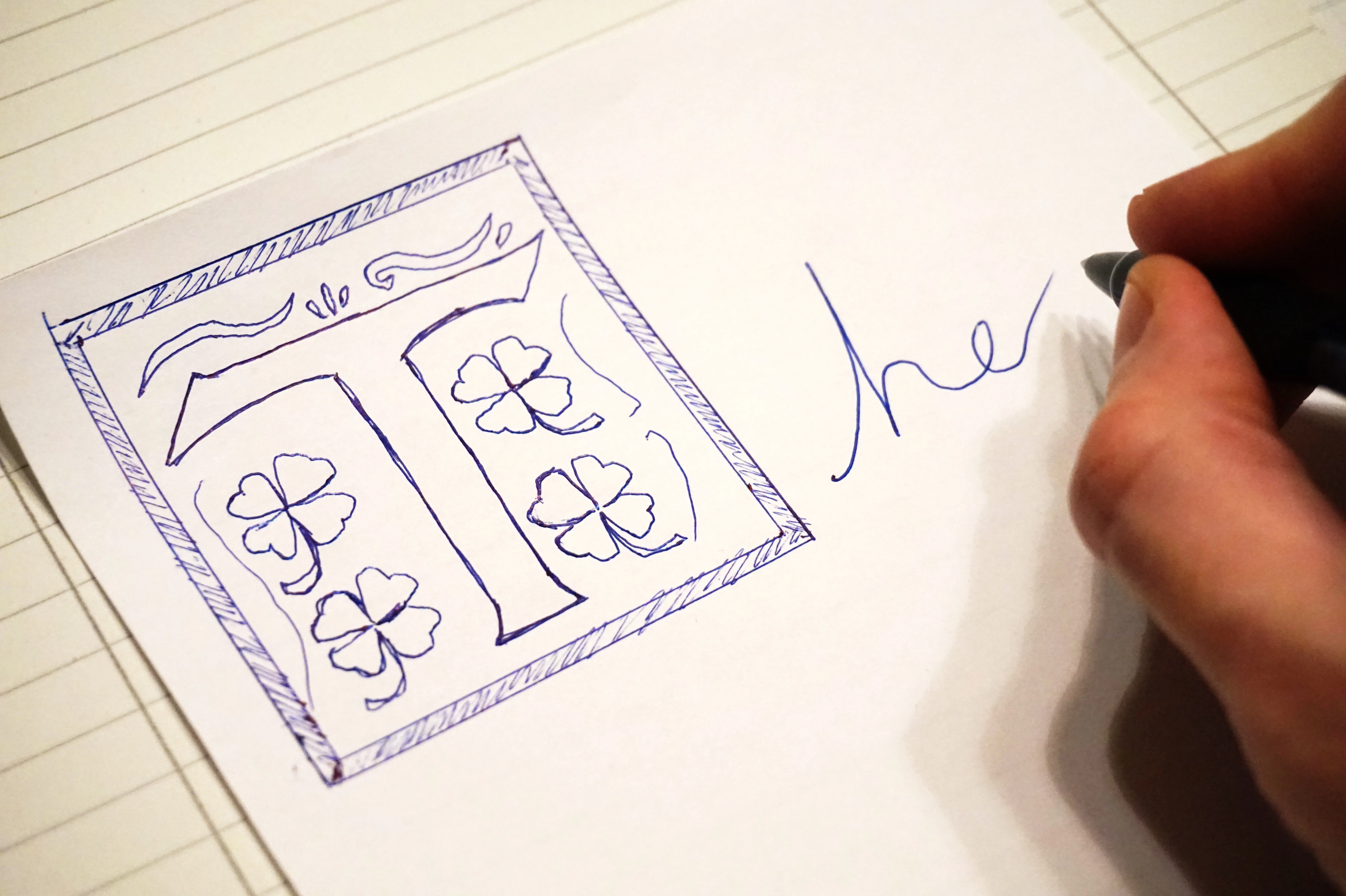 The word "The" handwritten with the T being elaborately drawn in an over the top style